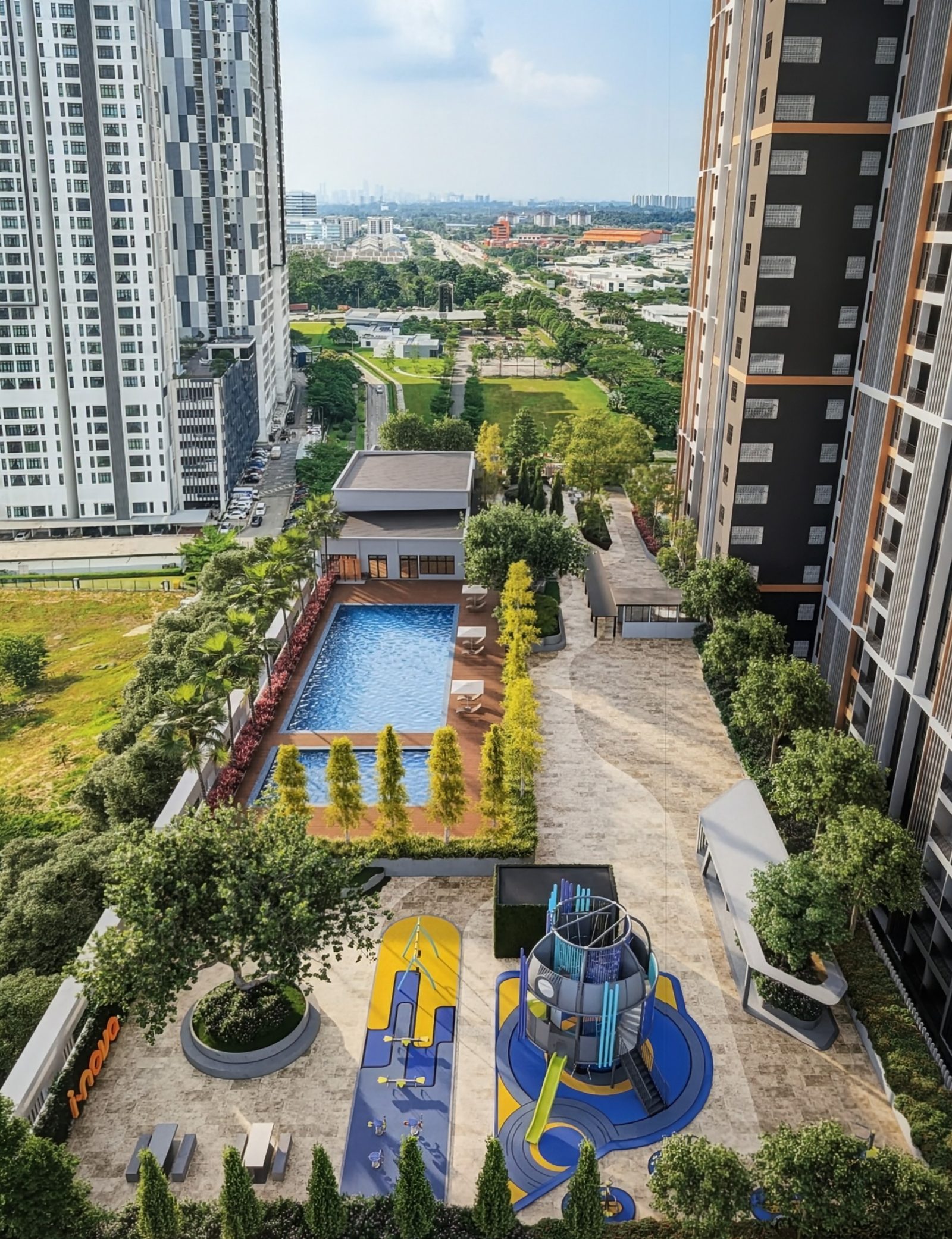 Aerial view of the pool deck and landscaped garden between the towers